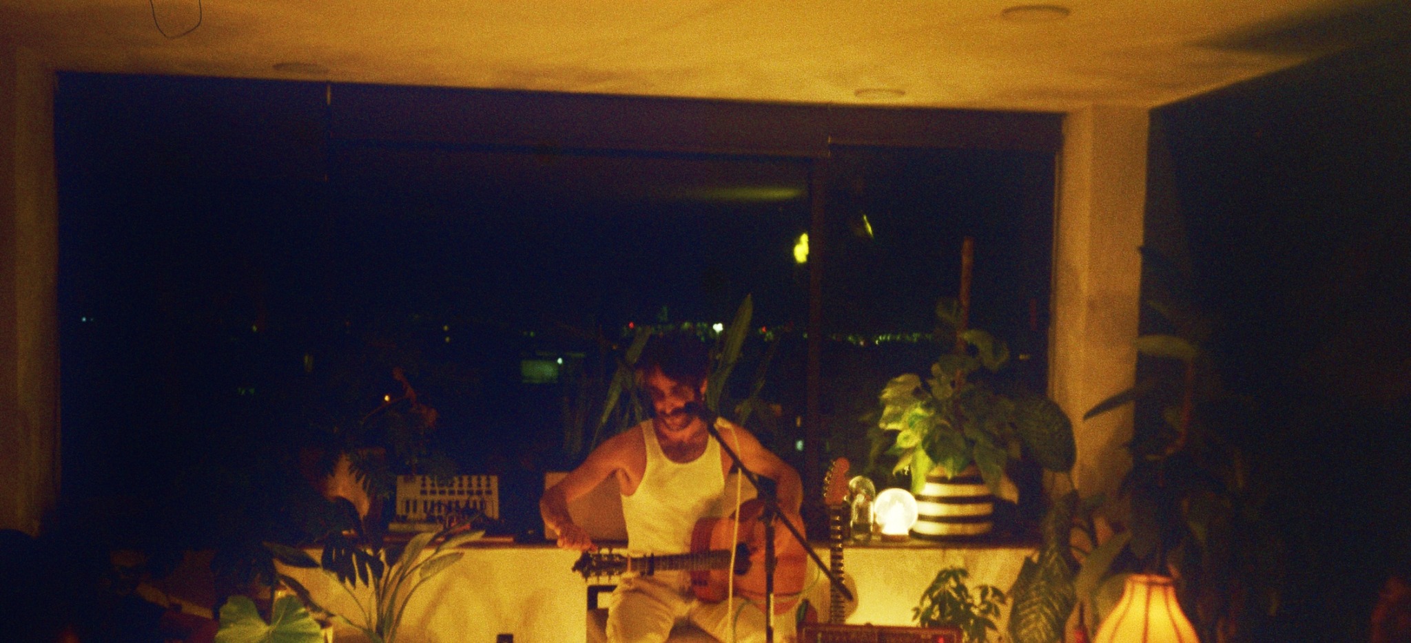 LIUSH playing guitar during a live performance